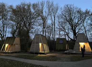Sciencehytterne med lys om aftenen