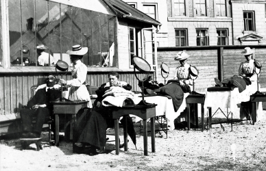 Sort hvid foto af personer der får lysbehandling i 1800-tallet