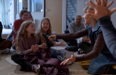 Billede af en pige, der taler ind i en mikrofon 